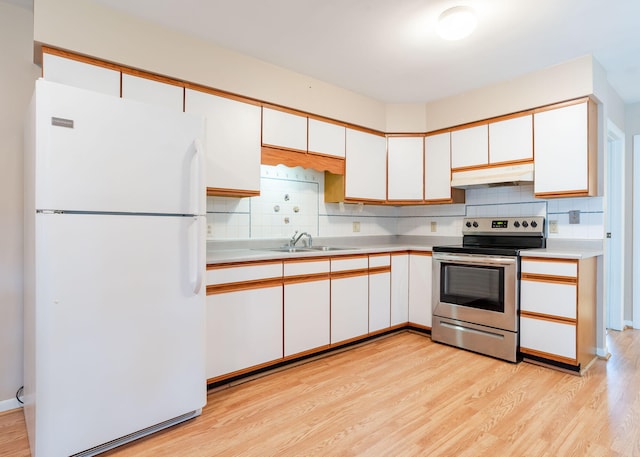 919 College St, Lewiston, ME 04240 - kitchen featuring freestanding refrigerator, stainless steel electric stove, under cabinet range hood, light countertops, and tasteful backsplash
