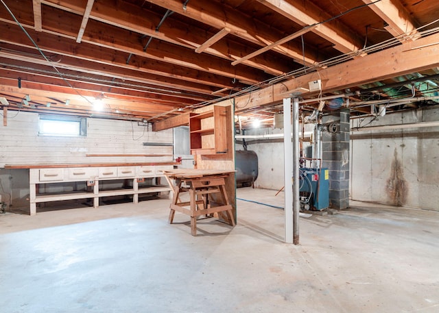 919 College St, Lewiston, ME 04240 - basement featuring oil tank, a heating unit, and a workshop area