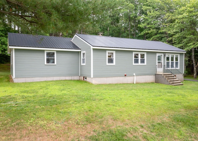 919 College St, Lewiston, ME 04240 - rear view of house with a metal roof and a yard