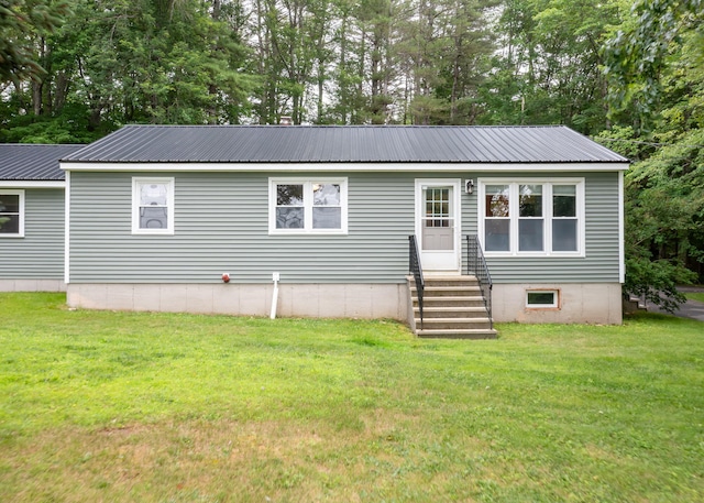 919 College St, Lewiston, ME 04240 - view of front of house with entry steps, a front yard, and a metal roof