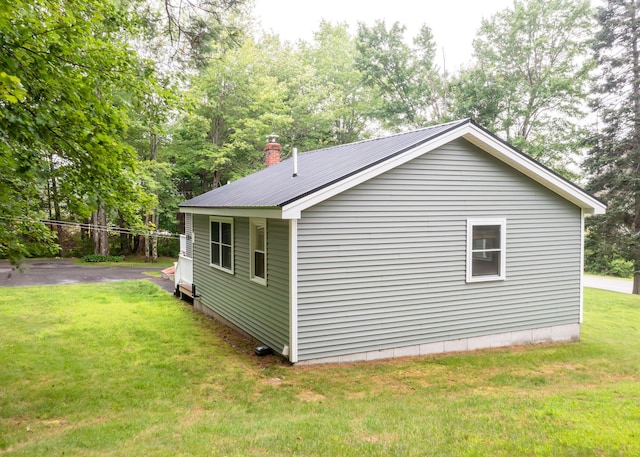 919 College St, Lewiston, ME 04240 - view of home's exterior featuring a lawn and a metal roof