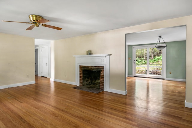 24 Littlejohn Rd, Cape Elizabeth, ME 04107 - unfurnished living room featuring a ceiling fan, a fireplace, and wood finished floors