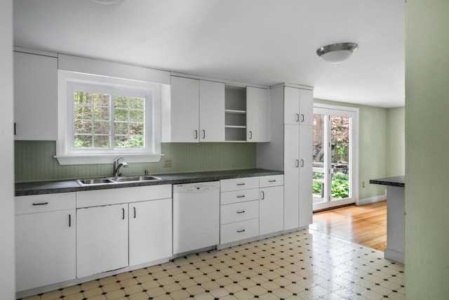24 Littlejohn Rd, Cape Elizabeth, ME 04107 - kitchen with white dishwasher, open shelves, dark countertops, and plenty of natural light