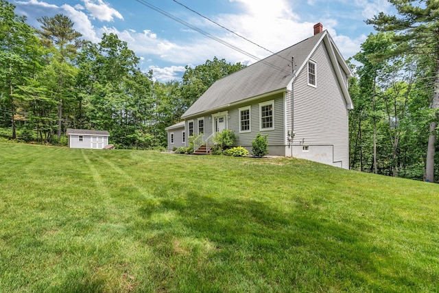 31 Pond Ridge Dr, Lewiston, ME 04240 - view of front of property featuring a chimney, a storage unit, and a front yard
