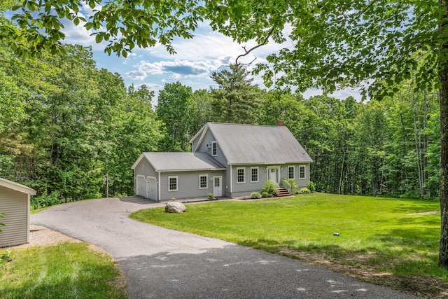 31 Pond Ridge Dr, Lewiston, ME 04240 - view of front of home with a forest view, a front yard, a garage, and driveway