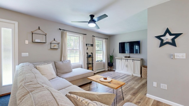31 Pond Ridge Dr, Lewiston, ME 04240 - living room featuring light wood-style flooring, ceiling fan, and a baseboard heating unit