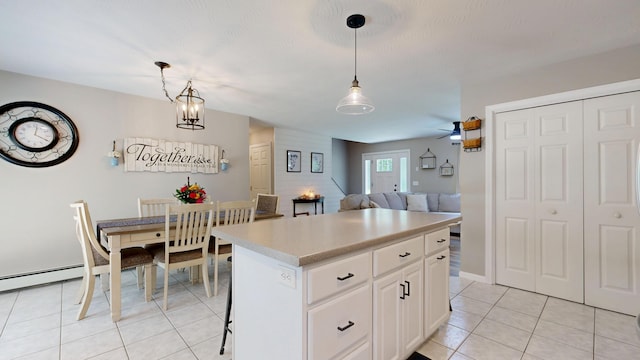 31 Pond Ridge Dr, Lewiston, ME 04240 - kitchen featuring light tile patterned flooring, light countertops, pendant lighting, and a center island