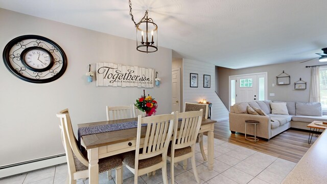 31 Pond Ridge Dr, Lewiston, ME 04240 - dining area featuring a baseboard heating unit, light tile patterned floors, and stairs