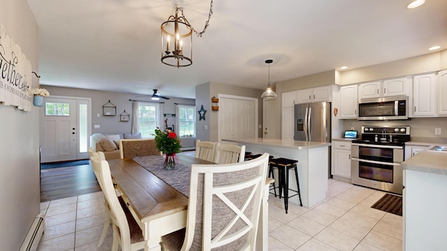 31 Pond Ridge Dr, Lewiston, ME 04240 - dining area featuring a baseboard heating unit, light tile patterned flooring, recessed lighting, and ceiling fan