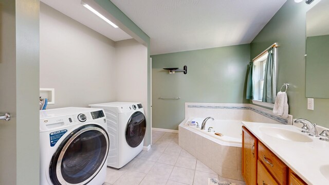 31 Pond Ridge Dr, Lewiston, ME 04240 - laundry area featuring washer and clothes dryer and light tile patterned floors