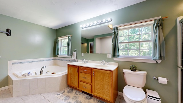 31 Pond Ridge Dr, Lewiston, ME 04240 - bathroom featuring a garden tub, double vanity, plenty of natural light, and tile patterned floors