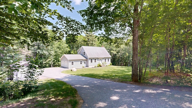 31 Pond Ridge Dr, Lewiston, ME 04240 - view of front facade with a front yard, driveway, an attached garage, and a forest view