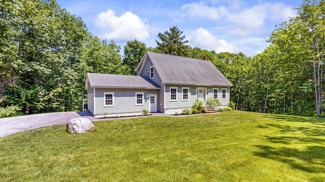 31 Pond Ridge Dr, Lewiston, ME 04240 - view of front of home with a front lawn, a chimney, and roof with shingles