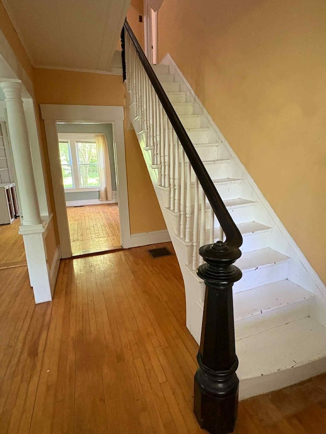 18 Clark St, Calais, ME 04619 - stairs featuring hardwood / wood-style flooring and decorative columns