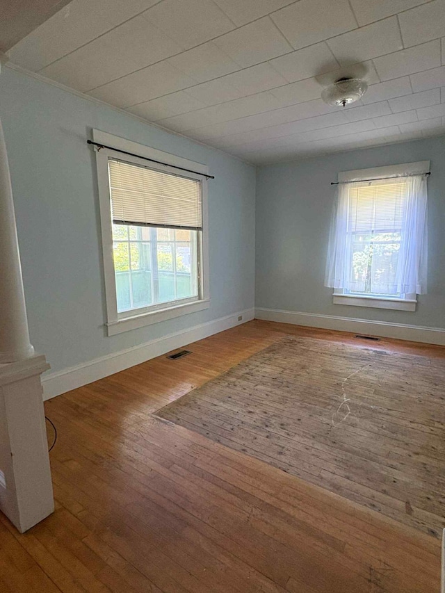 18 Clark St, Calais, ME 04619 - empty room with healthy amount of natural light and hardwood / wood-style flooring