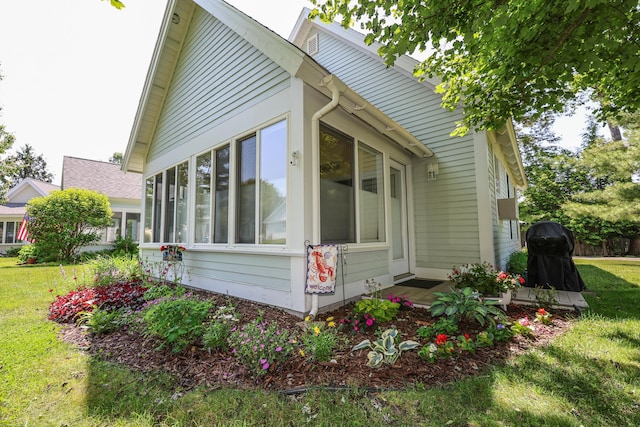 454 Post Rd Unit 464, Wells, ME 04090 - view of home's exterior with a sunroom and a yard