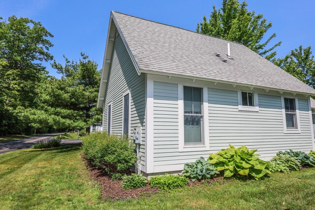 454 Post Rd Unit 464, Wells, ME 04090 - view of property exterior featuring a shingled roof and a lawn