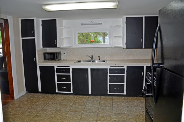 10 Stevens St, Norway, ME 04268 - kitchen with freestanding refrigerator, stainless steel microwave, dark cabinetry, and light countertops