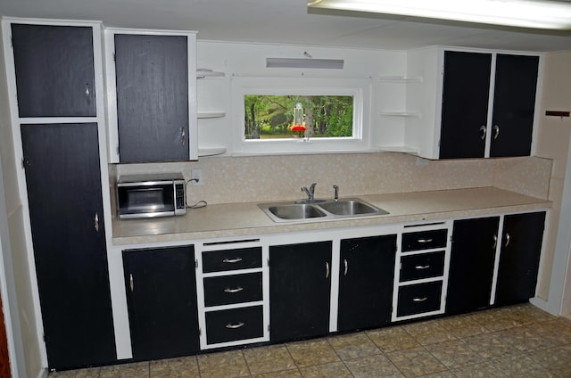 10 Stevens St, Norway, ME 04268 - kitchen featuring stainless steel microwave, dark cabinetry, open shelves, and light countertops