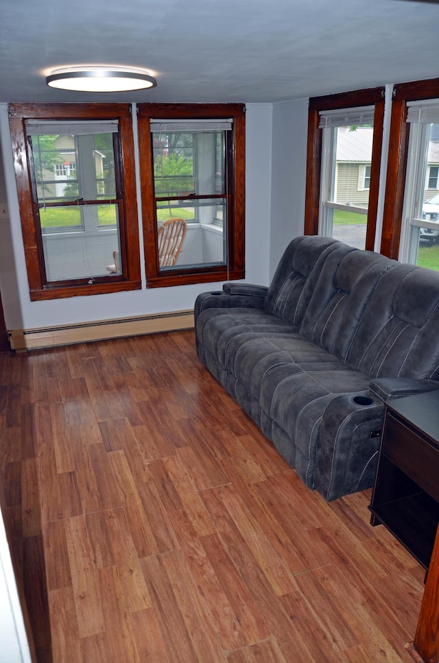10 Stevens St, Norway, ME 04268 - living room featuring a baseboard heating unit, wood finished floors, and healthy amount of natural light
