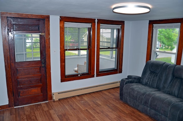 10 Stevens St, Norway, ME 04268 - living room featuring a baseboard radiator, wood finished floors, and healthy amount of natural light