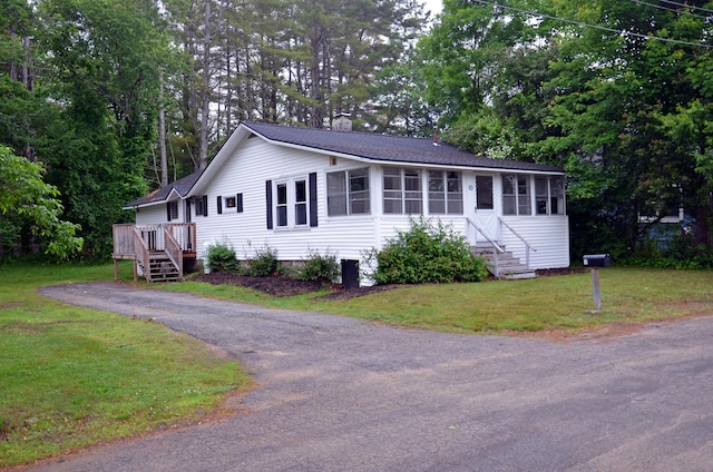 10 Stevens St, Norway, ME 04268 - view of front of home with a sunroom, a chimney, a front lawn, and stairs
