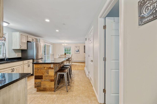 19 Fox Run Rd, Gray, ME 04039 - kitchen with a kitchen breakfast bar, a chandelier, recessed lighting, light brown cabinetry, and light tile patterned floors