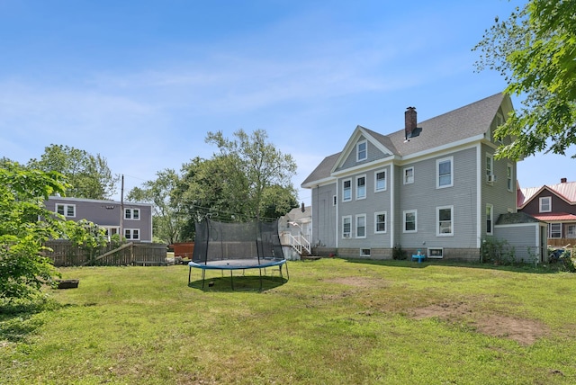 93 Chapel St, South Portland, ME 04106 - back of property featuring a trampoline, a chimney, and a shingled roof