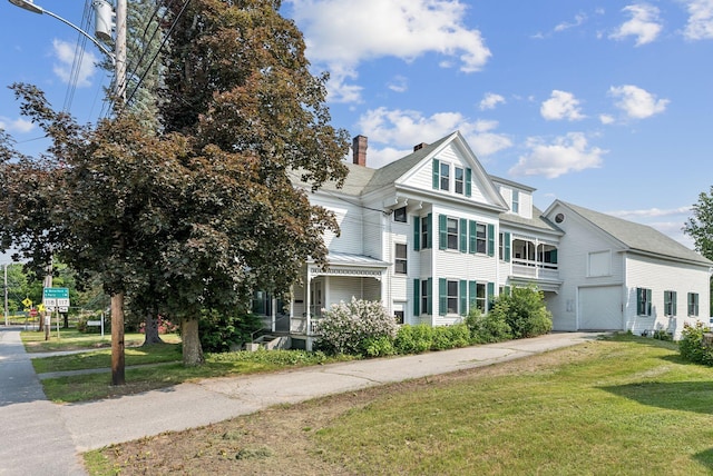 201 Main St, Norway, ME 04268 - view of front facade featuring a chimney, a front yard, and driveway