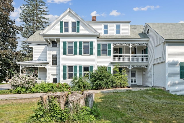 201 Main St, Norway, ME 04268 - rear view of house featuring a balcony, a lawn, and a chimney