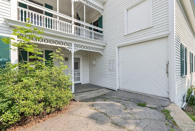 201 Main St, Norway, ME 04268 - property entrance featuring a balcony, an attached garage, and covered porch