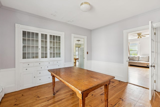 201 Main St, Norway, ME 04268 - dining area featuring light wood finished floors, crown molding, and wainscoting