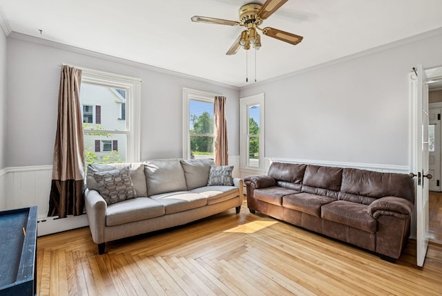 201 Main St, Norway, ME 04268 - living room with a baseboard radiator, crown molding, ceiling fan, and a wainscoted wall