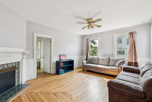201 Main St, Norway, ME 04268 - living area featuring a ceiling fan, wainscoting, radiator heating unit, a premium fireplace, and crown molding