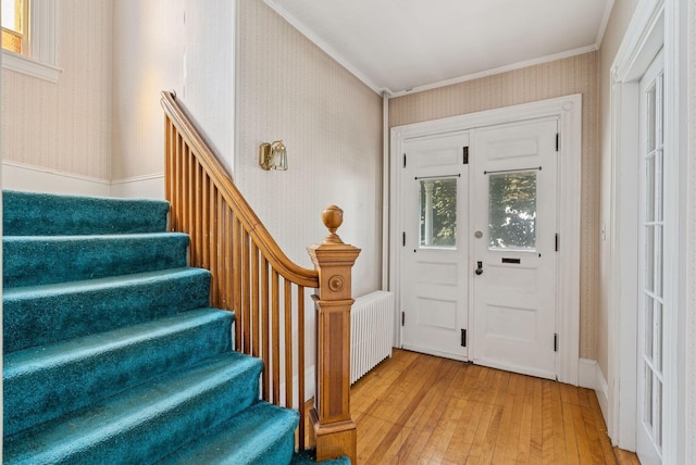 201 Main St, Norway, ME 04268 - foyer featuring wallpapered walls, hardwood / wood-style floors, stairway, ornamental molding, and radiator