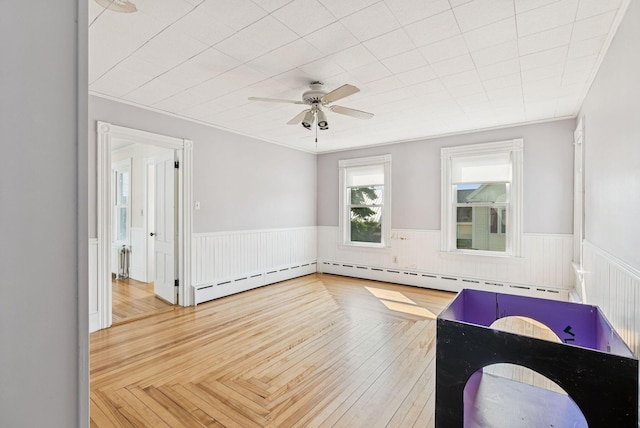 201 Main St, Norway, ME 04268 - empty room with wainscoting, a ceiling fan, and a baseboard radiator