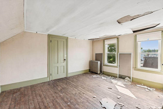 201 Main St, Norway, ME 04268 - unfurnished room featuring radiator, hardwood / wood-style flooring, and lofted ceiling