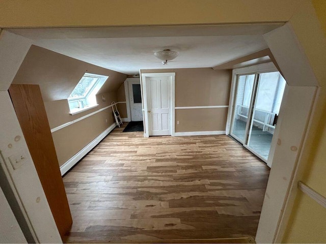 323 Pine St, Dover-Foxcroft, ME 04426 - additional living space with wood finished floors, lofted ceiling, and baseboard heating
