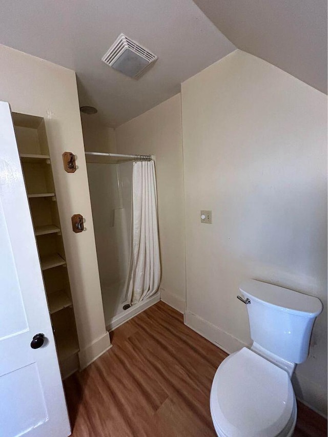 323 Pine St, Dover-Foxcroft, ME 04426 - full bathroom with wood finished floors, curtained shower, and lofted ceiling