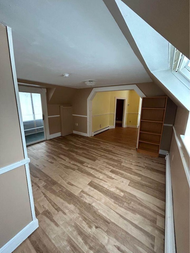 323 Pine St, Dover-Foxcroft, ME 04426 - additional living space featuring baseboard heating, light wood-style flooring, and vaulted ceiling