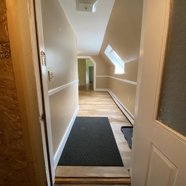 323 Pine St, Dover-Foxcroft, ME 04426 - bonus room featuring a baseboard heating unit, wood finished floors, and vaulted ceiling