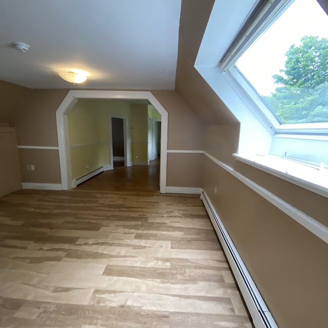 323 Pine St, Dover-Foxcroft, ME 04426 - bonus room featuring a baseboard heating unit, light wood-style floors, vaulted ceiling, and a skylight