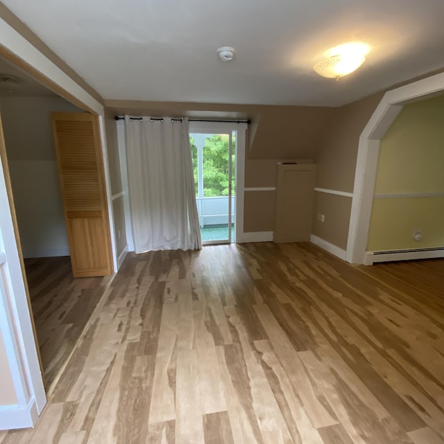 323 Pine St, Dover-Foxcroft, ME 04426 - unfurnished living room with baseboard heating and light wood-type flooring