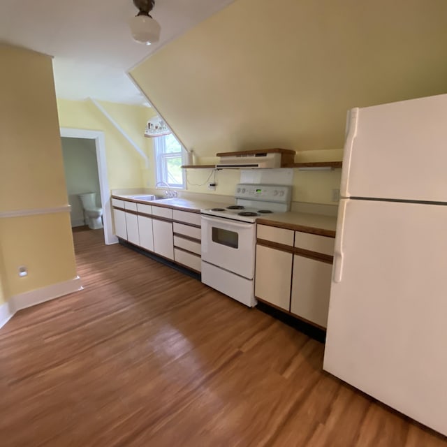 323 Pine St, Dover-Foxcroft, ME 04426 - kitchen featuring white appliances, under cabinet range hood, wood finished floors, white cabinets, and light countertops