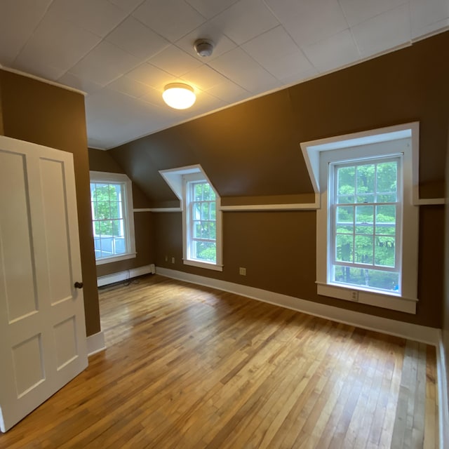 323 Pine St, Dover-Foxcroft, ME 04426 - additional living space with a baseboard heating unit, hardwood / wood-style flooring, and lofted ceiling