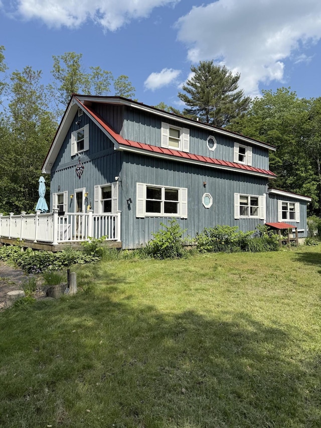 333 Mohawk Rd, Enfield, ME 04493 - rustic home with a metal roof, a deck, and a front yard