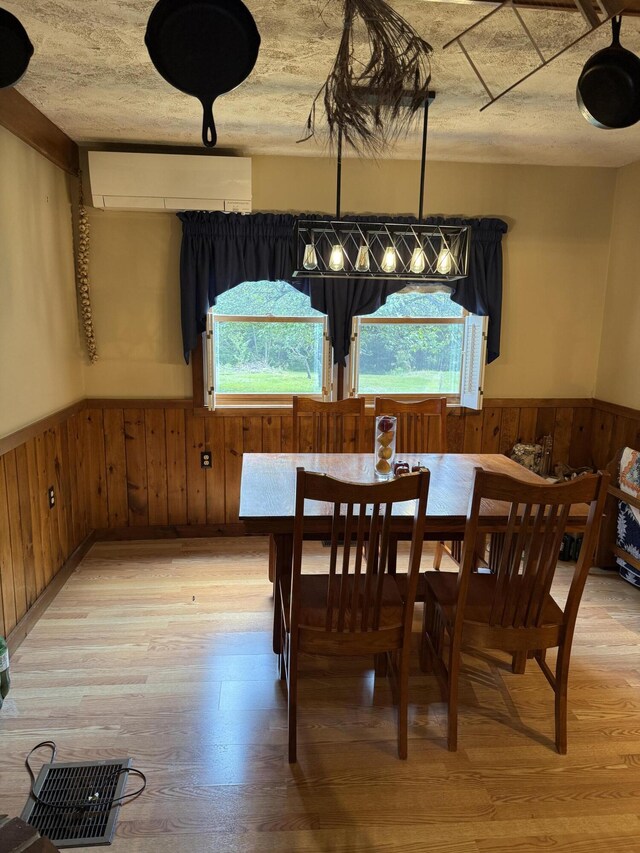 333 Mohawk Rd, Enfield, ME 04493 - dining area with healthy amount of natural light, a wainscoted wall, wooden walls, and light wood-style floors