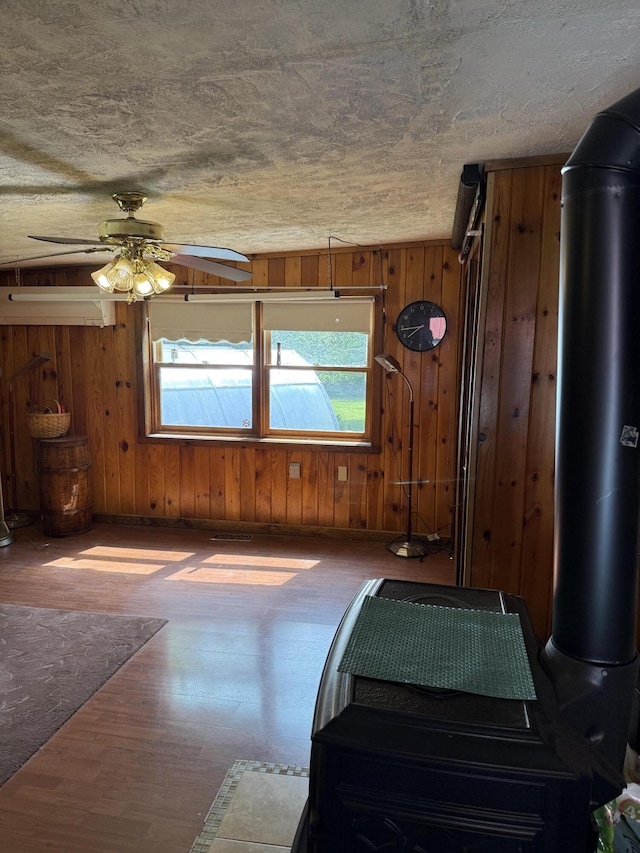 333 Mohawk Rd, Enfield, ME 04493 - bedroom with wood finished floors, wooden walls, and ceiling fan