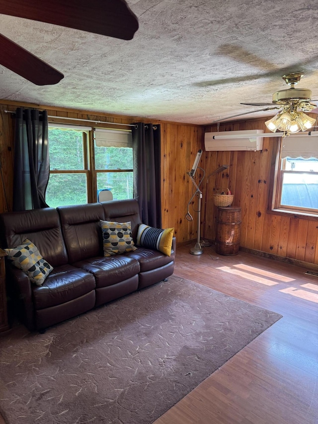 333 Mohawk Rd, Enfield, ME 04493 - living area featuring ceiling fan, wood finished floors, a textured ceiling, and wooden walls