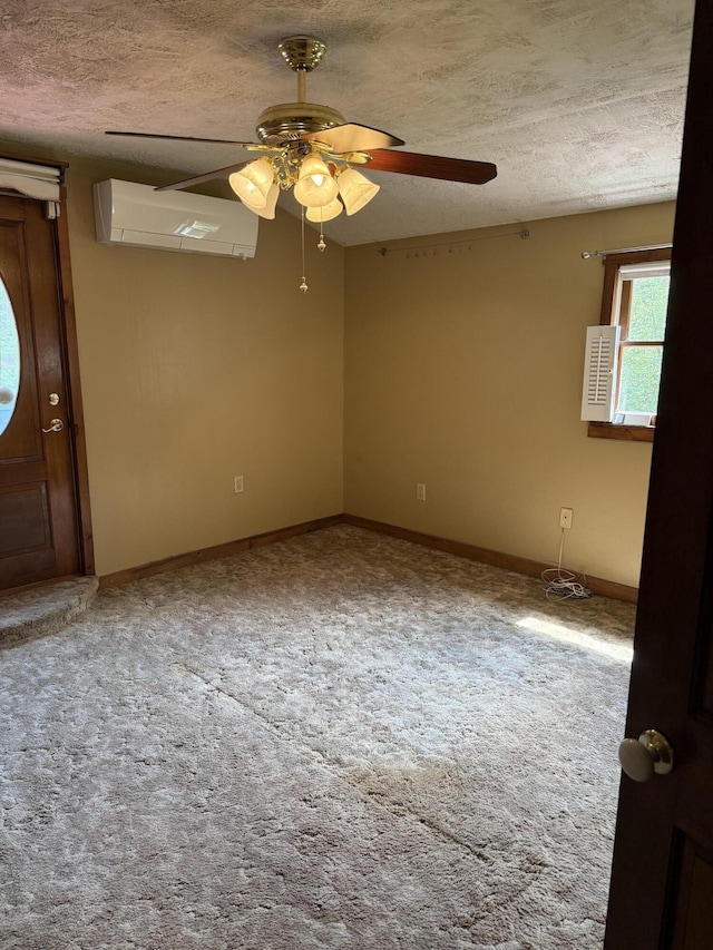 333 Mohawk Rd, Enfield, ME 04493 - spare room with a wall mounted air conditioner, ceiling fan, a textured ceiling, and carpet flooring